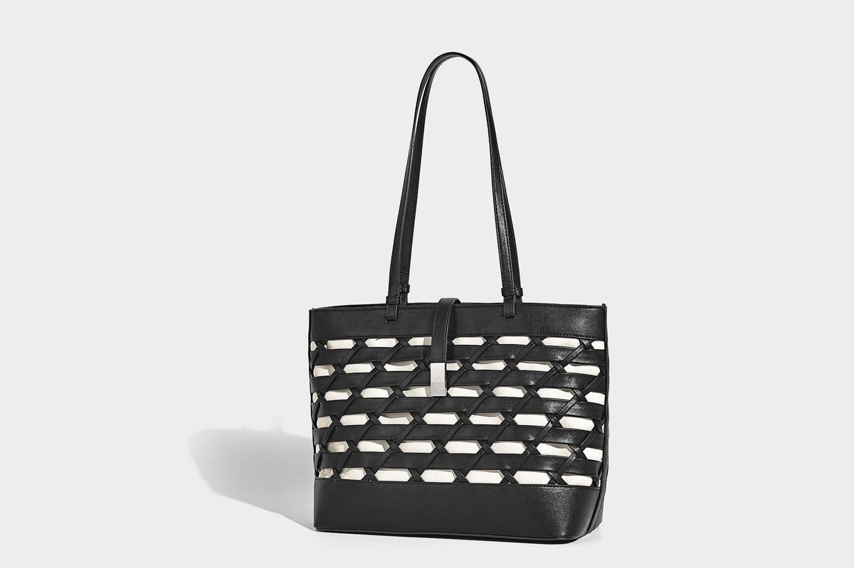 Structured woven lattice cutout tote bag with smooth leather-look trim, dual shoulder straps, and silver-tone hardware