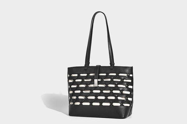 Structured woven lattice cutout tote bag with smooth leather-look trim, dual shoulder straps, and silver-tone hardware