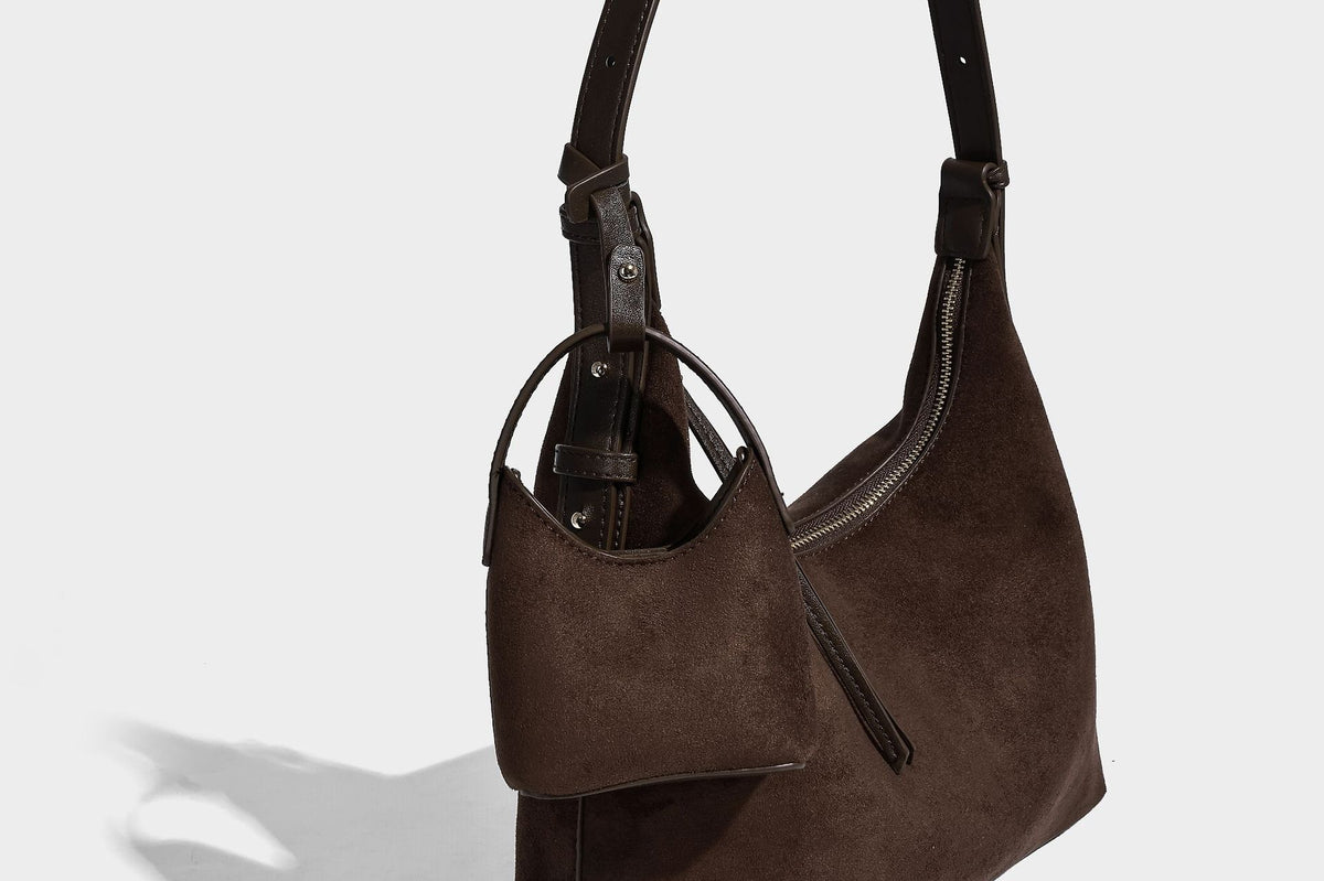 Dark brown suede-look hobo shoulder bag with top zip closure, adjustable strap, and small detachable mini pouch, detail view