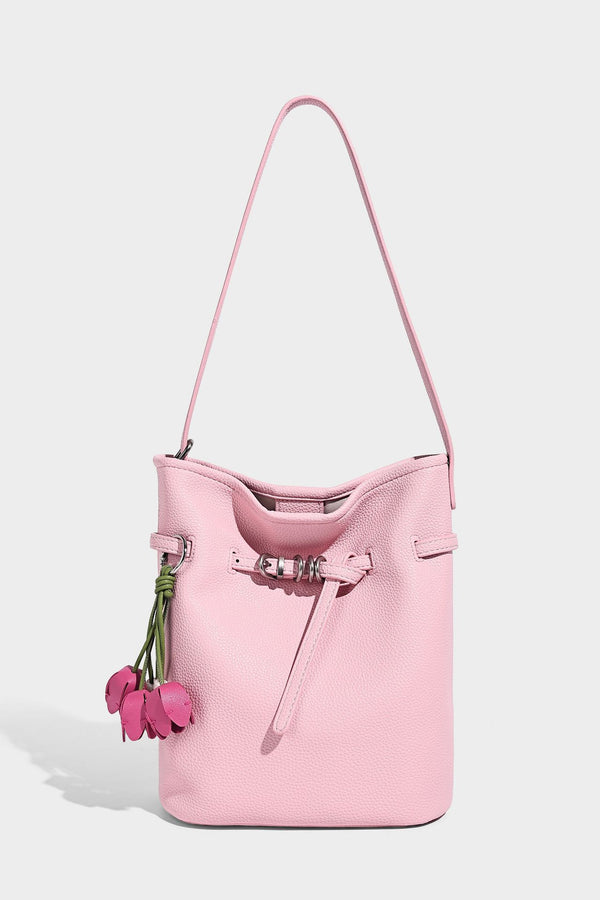 Small pebbled leather-look bucket bag with front drawstring toggle hardware and long adjustable shoulder strap, detail view