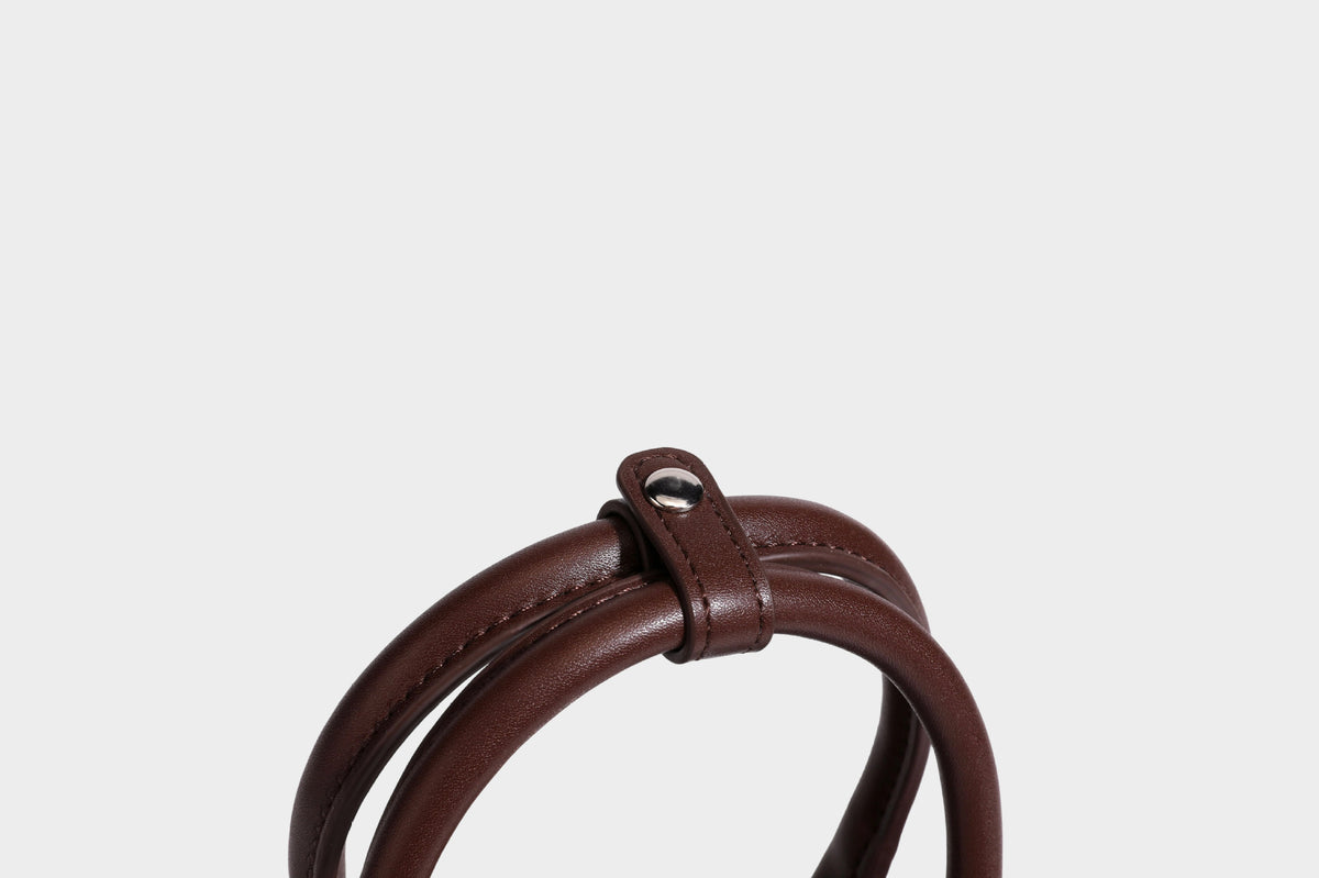Small structured satchel bag in dark brown velvet-like textured finish with leather-look trim, silver-tone turn-lock bar