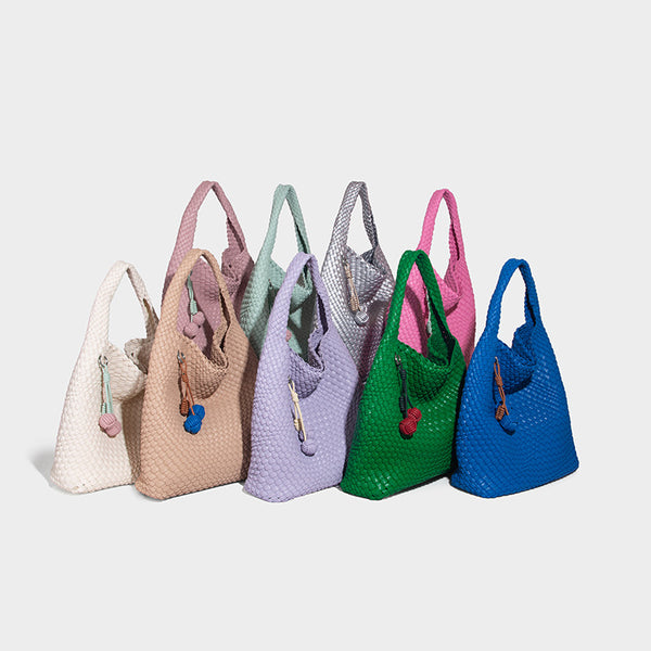 Soft hand-woven slouchy hobo tote bag with knotted tassel charm and single looped shoulder strap, detail view 2
