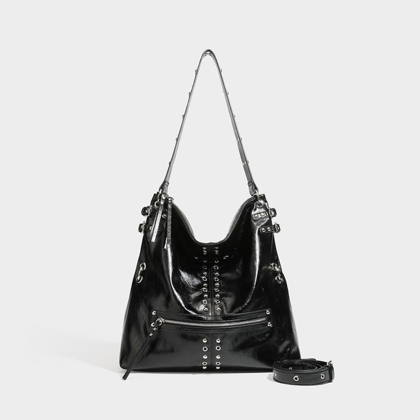 Black glossy leather-look slouchy shoulder bag with silver stud and eyelet hardware, top zip closure, front zip pocket, and