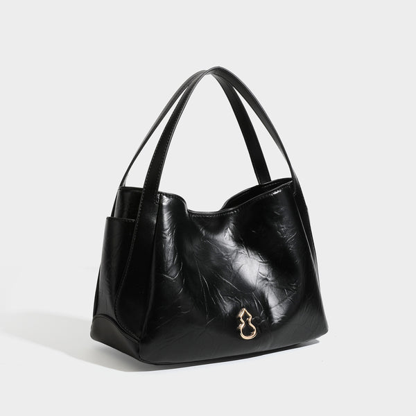 Black glossy crinkled leather-look convertible shoulder tote bag with gold gourd-shaped emblem hardware and detachable, front