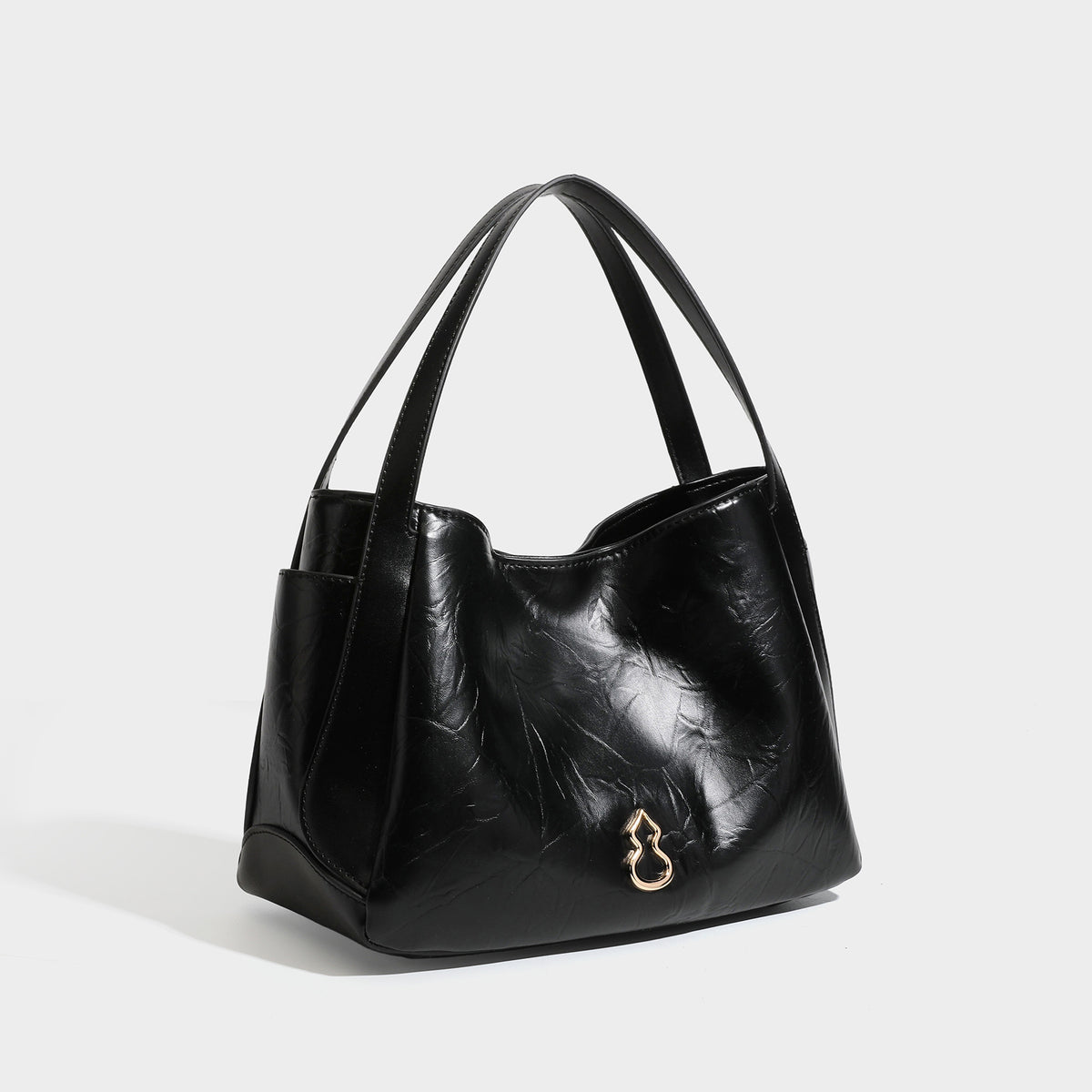 Black glossy crinkled leather-look convertible shoulder tote bag with gold gourd-shaped emblem hardware and detachable