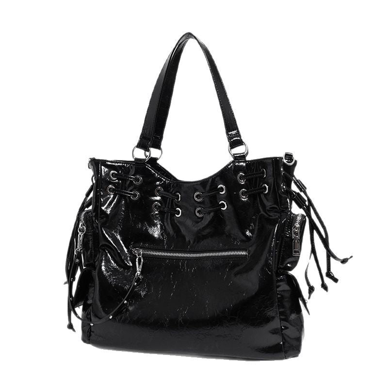 Glossy crinkled leather-look tote bag with silver grommet lace-up front detail, dual top handles, and detachable shoulder