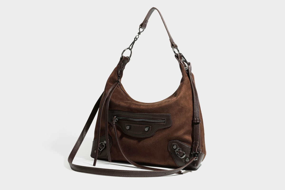 Slouchy suede-finish hobo shoulder bag with dark hardware, exterior zip pocket, tassel ties, and detachable crossbody strap
