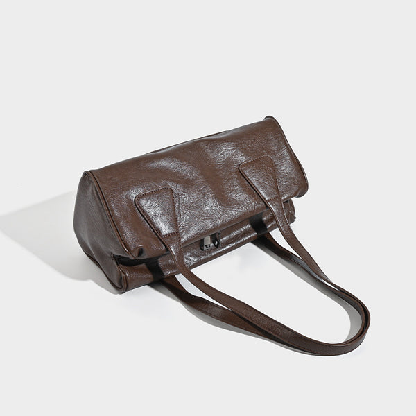 Glossy leather-look barrel shoulder bag with zip closure and top handles, detail view 4