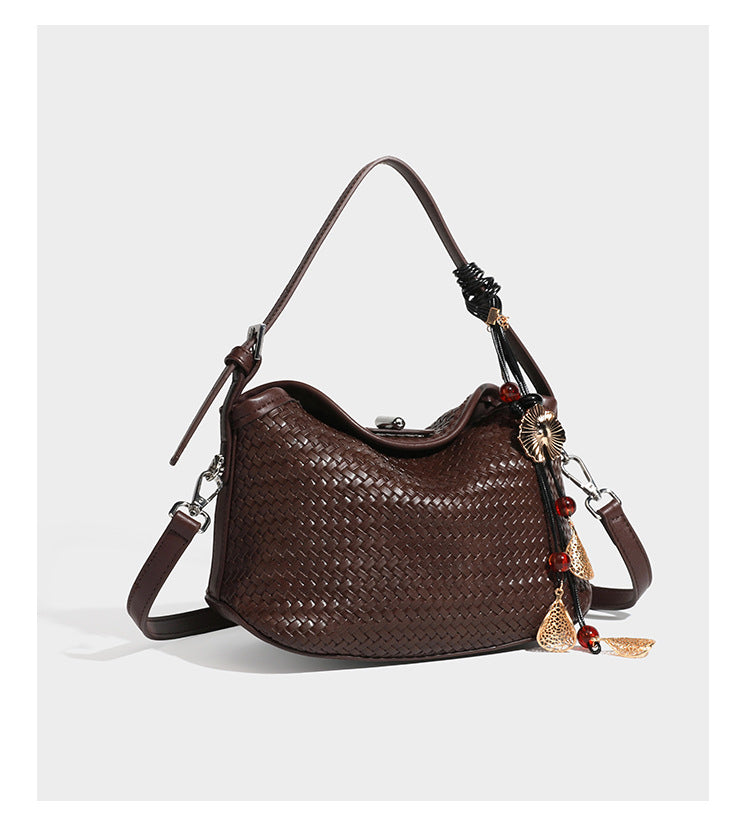 Small woven-look leather-look flap shoulder hobo bag in burgundy with silver-tone hardware and decorative tassel charm
