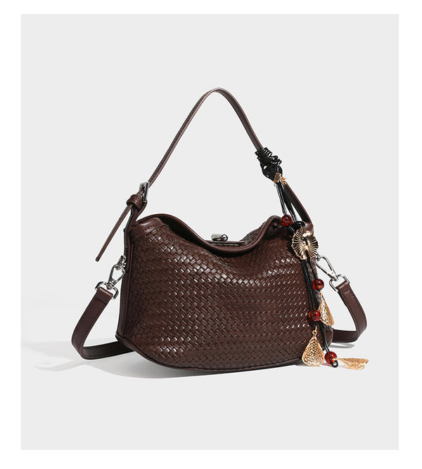 Small woven-look leather-look flap shoulder hobo bag in burgundy with silver-tone hardware and decorative tassel charm