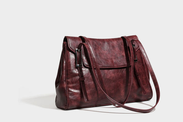 Structured flap-top shoulder tote bag in distressed leather-look finish with silver-tone buckle hardware and double shoulder