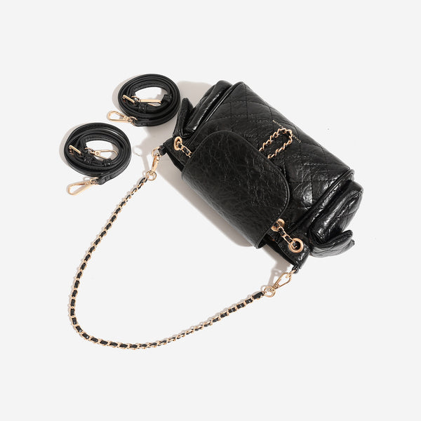 Compact quilted crinkle-finish flap bag with gold-tone chain strap and decorative chain closure detail, detail view 2