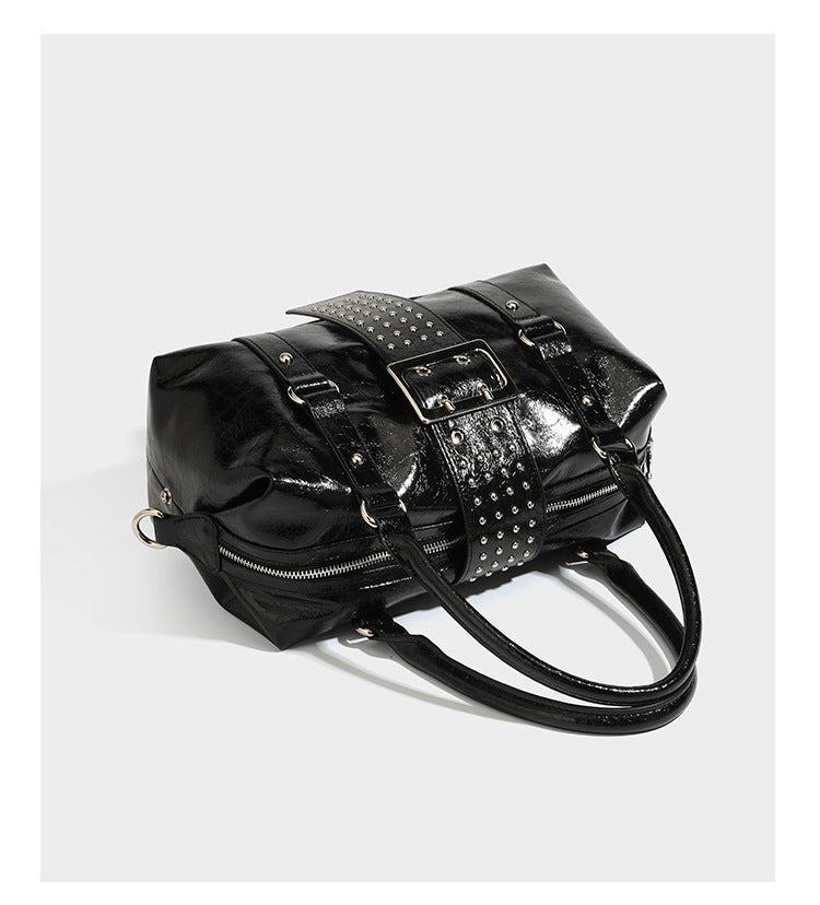 Glossy crinkled barrel handbag with silver stud buckle strap and detachable shoulder strap, detail view 11
