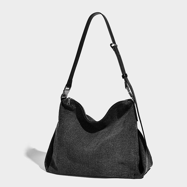 Charcoal denim-textured slouchy hobo bag with zip-top closure, silver-tone hardware, and adjustable leather-look crossbody