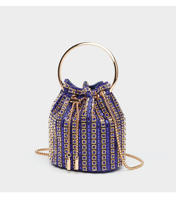 Mini crystal rhinestone bucket bag with circular ring top handle, drawstring closure, and silver chain shoulder strap, detail