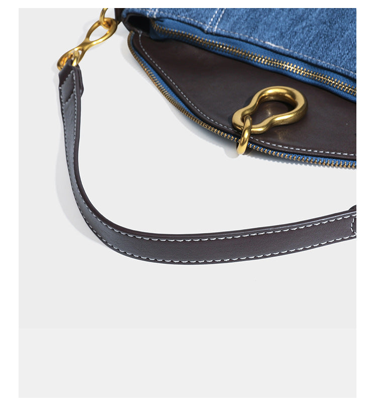 Slouchy denim shoulder bag with dark leather-look trim, gold-tone chain-link hardware, and top zipper closure, detail view 18