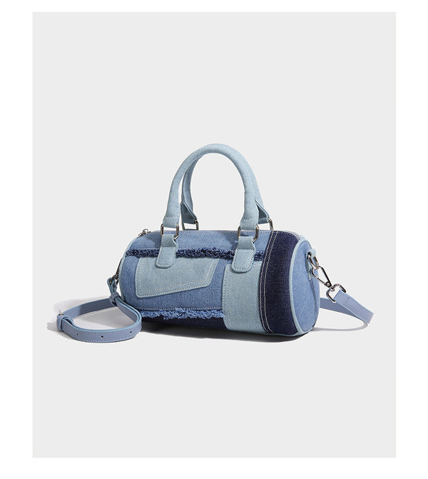 Mini barrel handbag in light and dark denim patchwork with frayed seam trim, dual top handles, top zip closure, and, detail