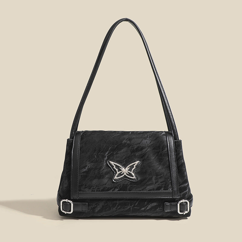 Structured crinkle-finish flap shoulder bag with butterfly metal appliqué and dark brown contrast trim, detail view 8