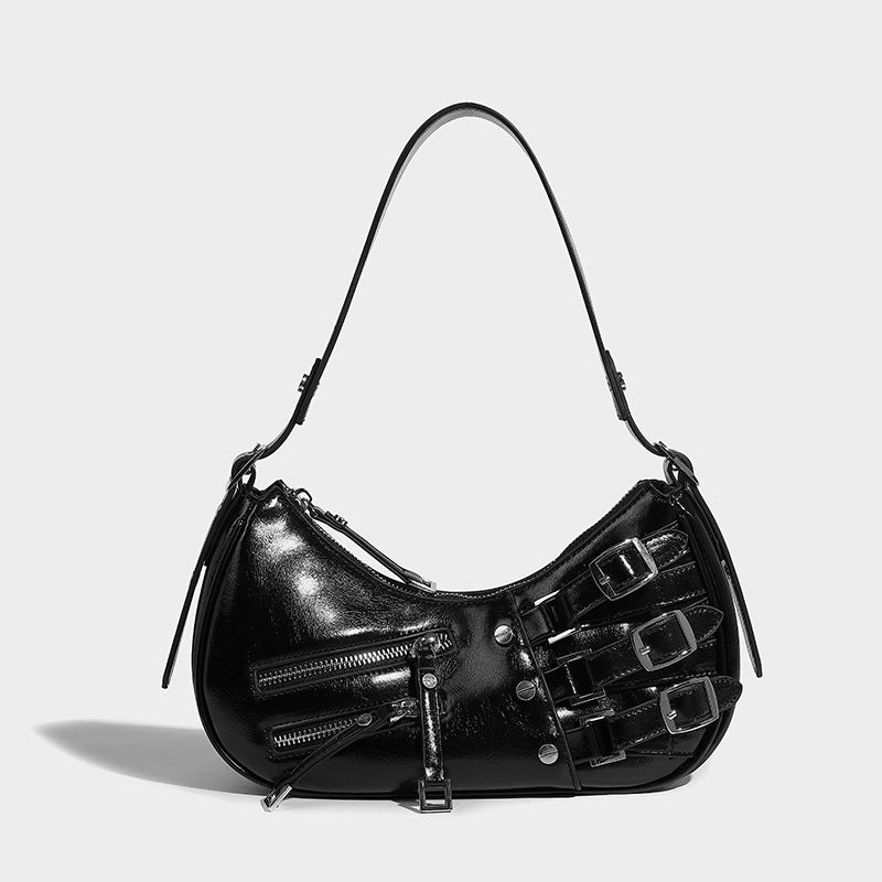 Crescent shoulder bag in washed blue denim-look PU with stacked buckle straps, front zip pocket, and silver-tone hardware