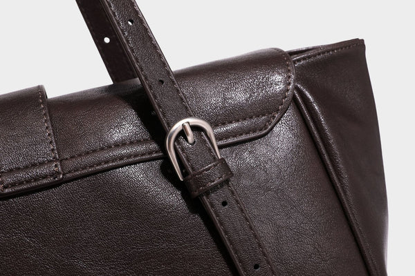 Large structured vintage-style tote bag with flap-front turn-lock closure, twin buckle straps, and double shoulder handles