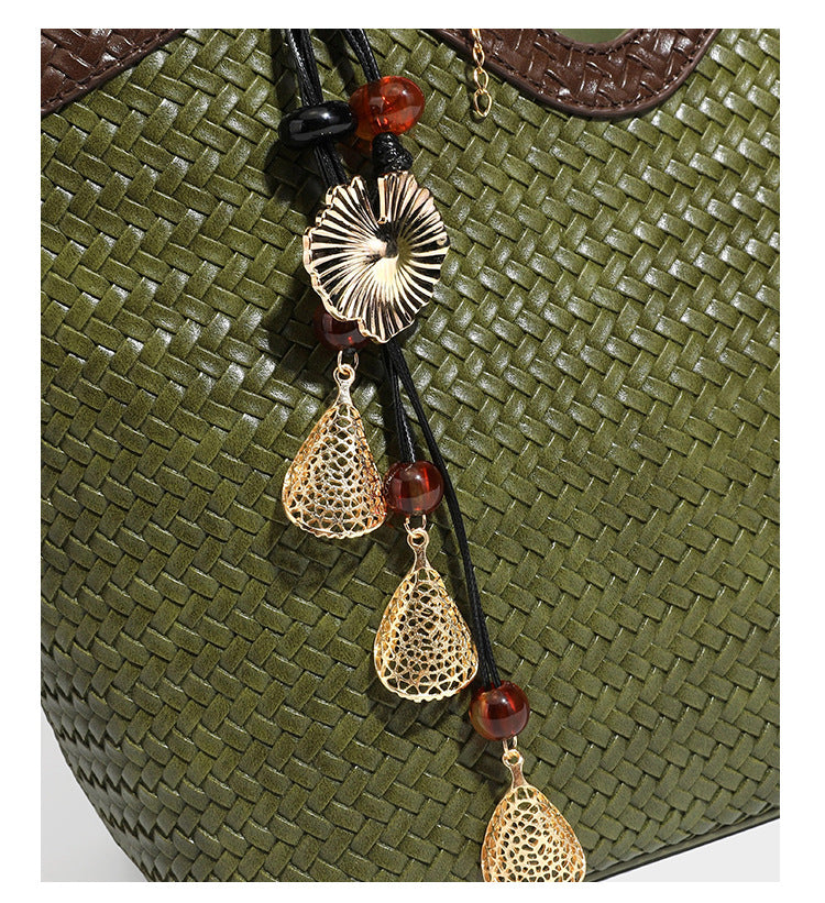 Woven tote bag with braided shoulder straps, drawstring closure, and dangling metal-and-bead charm, detail view 27