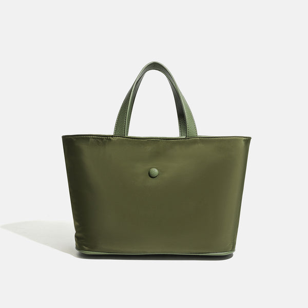 Structured lightweight nylon tote bag with textured double top handles and snap-button front detail, detail view 9