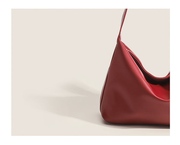 Large slouchy hobo shoulder bag in smooth leather-look finish with single long strap and gold-tone zip closure, detail view