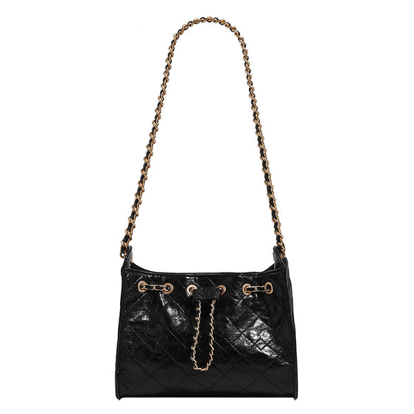 Glossy diamond-quilted drawstring bucket bag with gold-tone chain strap and eyelet hardware, detail view 5