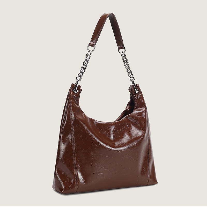 Glossy crinkled leather-look slouchy hobo bag with silver chain-and-leather shoulder strap and open top, detail view 3