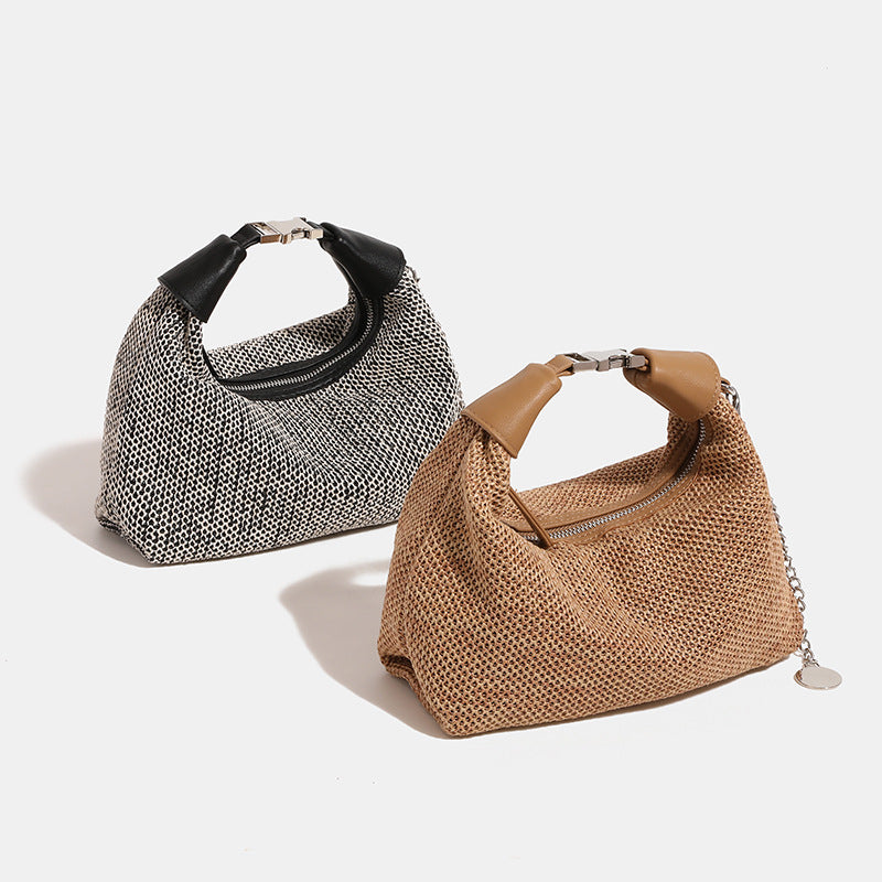 Woven straw hobo bag with leather-look knotted top handle, silver-tone hardware, and chain charm in black and tan colorways
