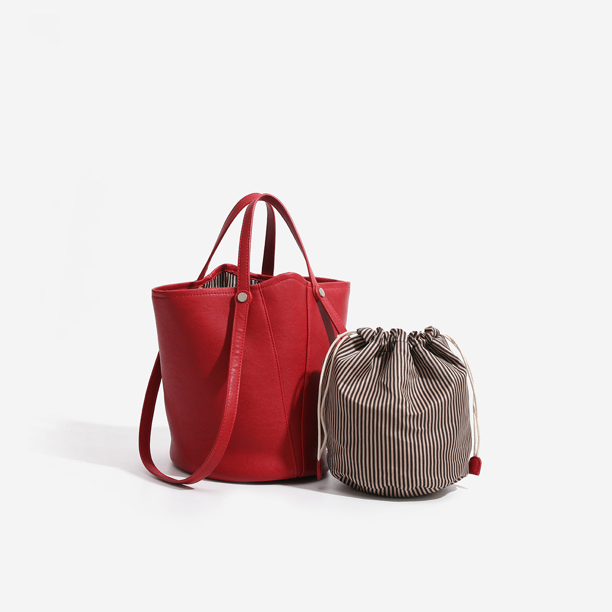 Large leather-look bucket tote bag with dual top handles and adjustable crossbody strap, detail view 4