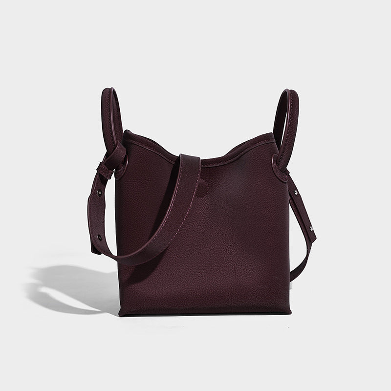 Small structured matte pebbled tote bag with twin top handles and removable zip pouch, detail view 3