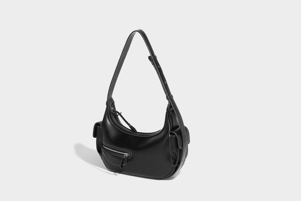 Smooth leather-look crescent shoulder bag with front zip pocket, side flap pockets, adjustable strap, and silver-tone, detail