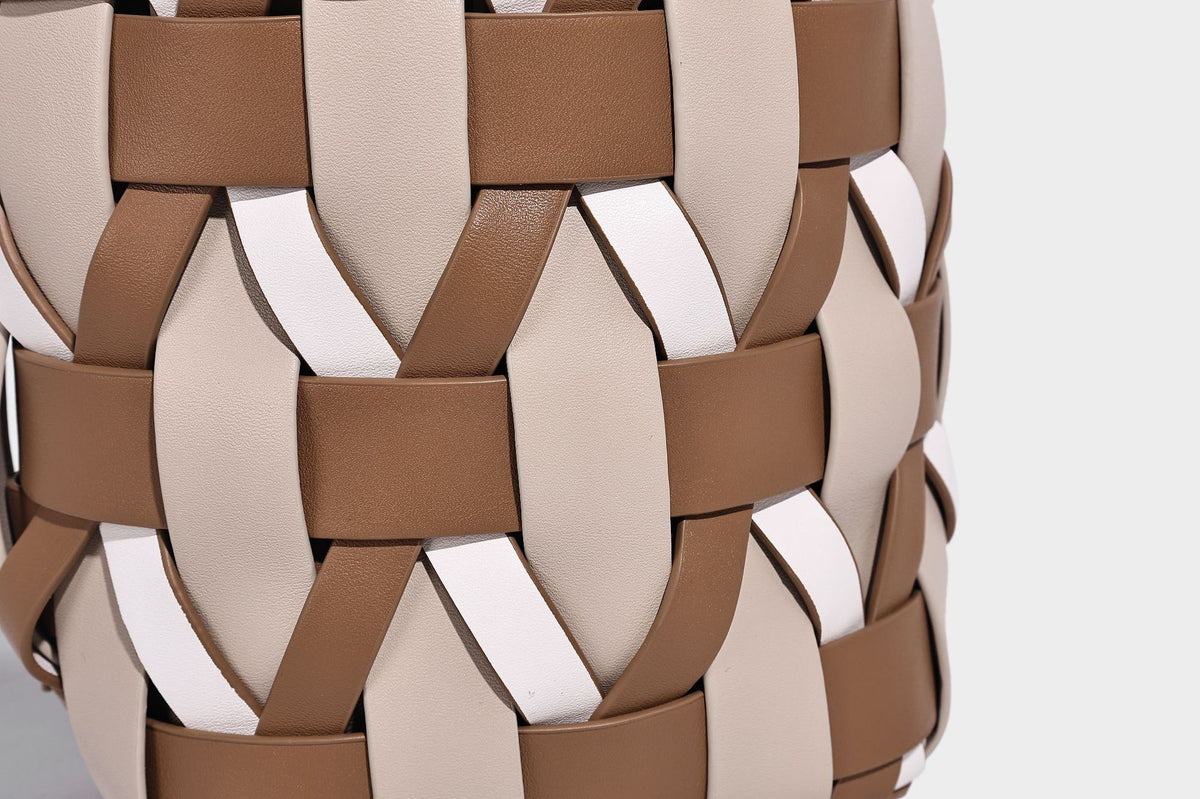 Small woven lattice bucket bag in tan and cream leather-look strips with drawstring top and detachable crossbody strap