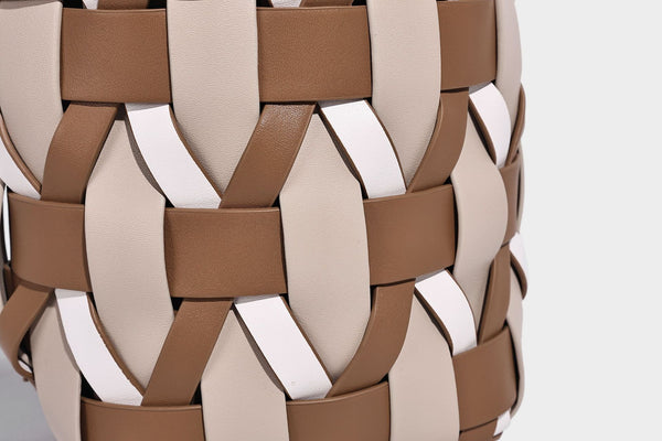 Small woven lattice bucket bag in tan and cream leather-look strips with drawstring top and detachable crossbody strap