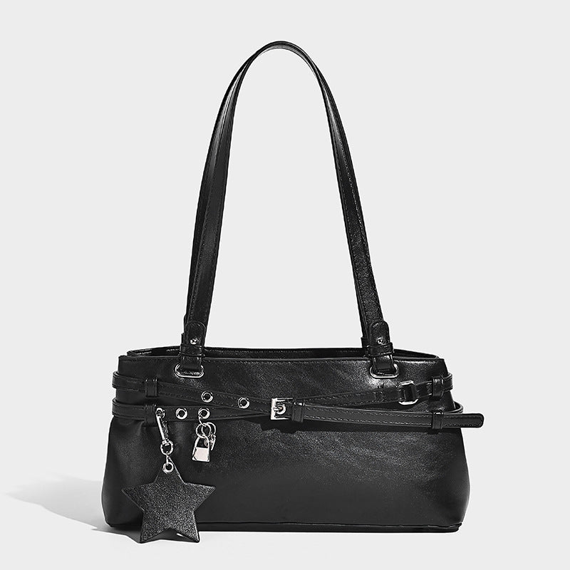 Structured glossy leather-look shoulder bag with wraparound belt straps, silver-tone hardware, and dangling star charm