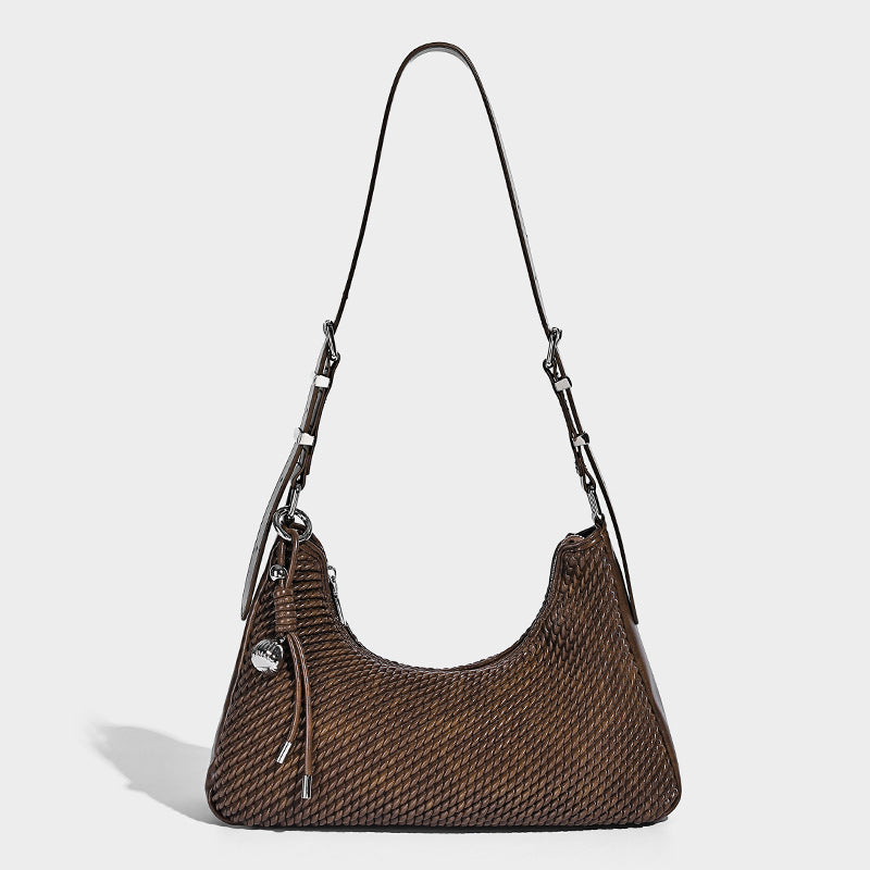 Woven crescent hobo shoulder bag with smooth side panels, zip-top closure, silver-tone charm hardware, and adjustable, detail