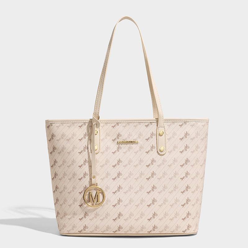 Structured large tote bag in vintage print with leather-look trim, gold-tone hardware, and top zip closure, front view