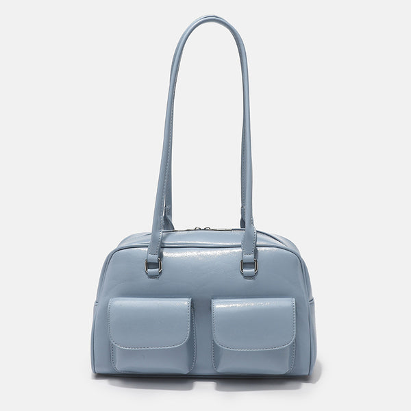Structured glossy leather-look bowling shoulder bag with two front flap pockets, top zip closure, and long double shoulder
