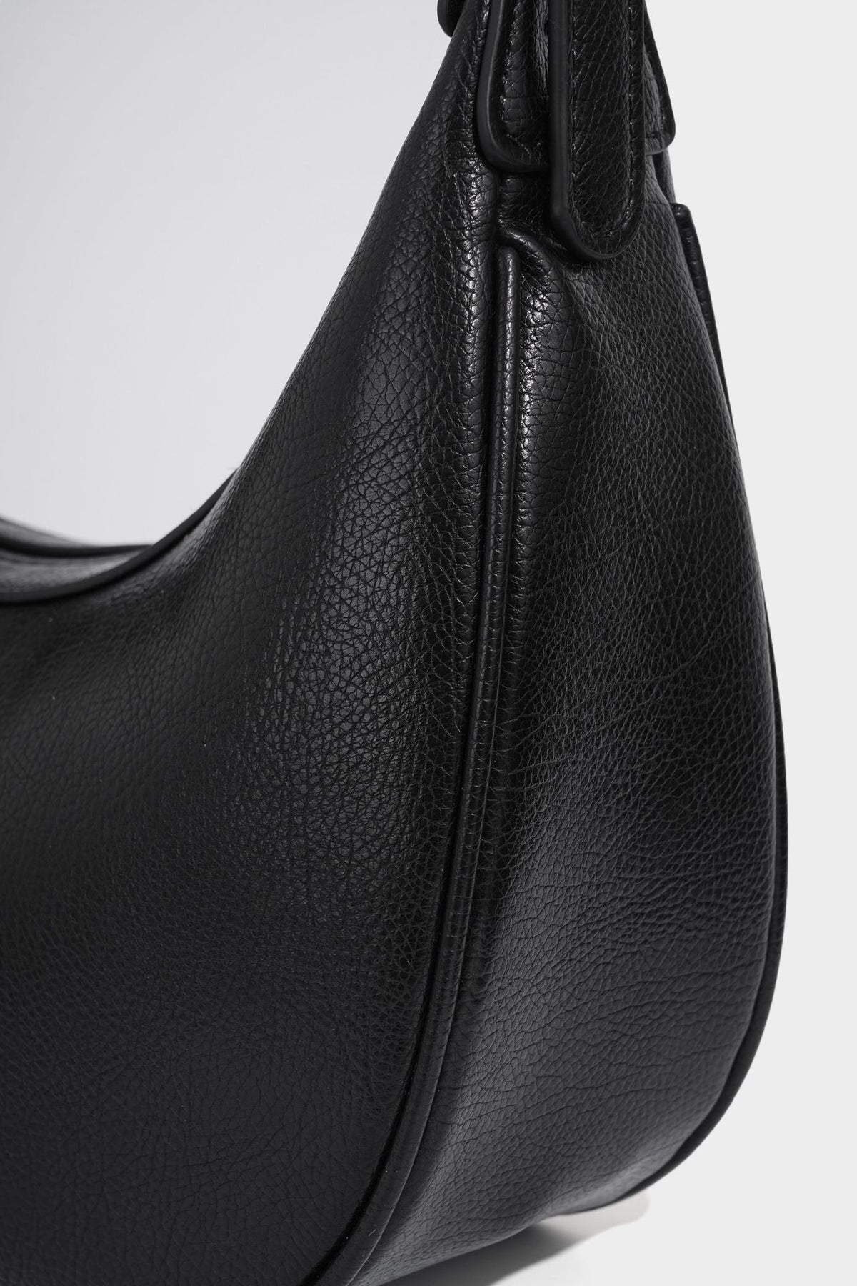 Crescent half-moon shoulder bag in pebbled leather-look finish with adjustable strap and silver-tone hardware, detail view 25