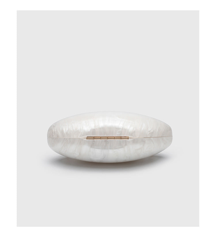 Oval hard-shell marbled gloss clutch bag with gold-tone kiss-lock clasp and detachable gold chain strap, detail view 11