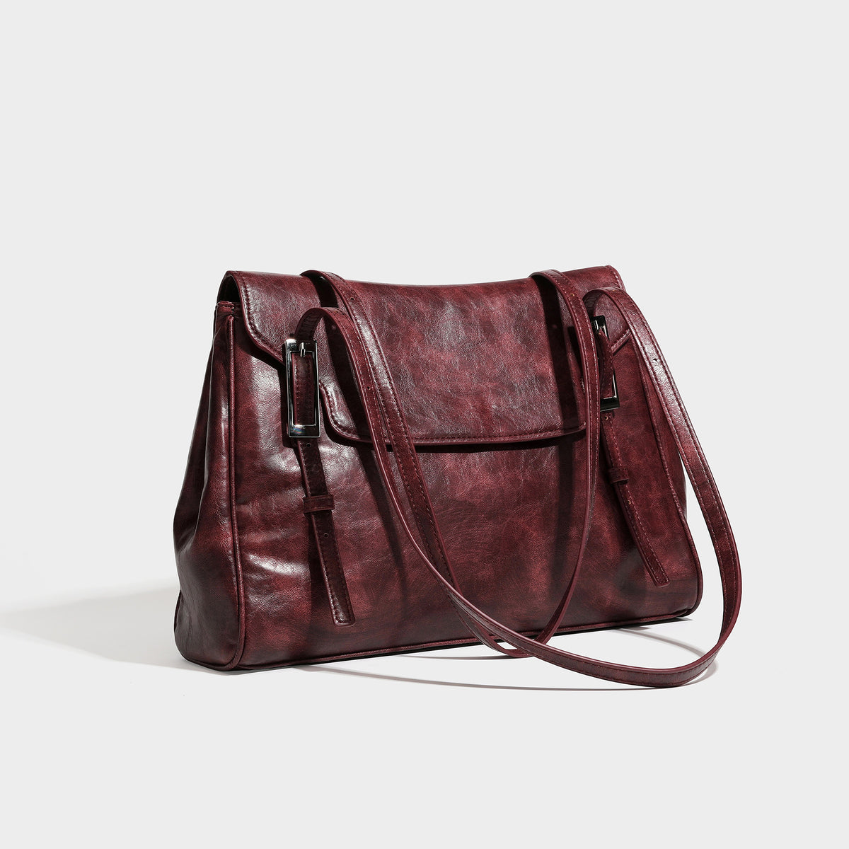 Structured flap-top shoulder tote bag in distressed leather-look finish with silver-tone buckle hardware and double shoulder