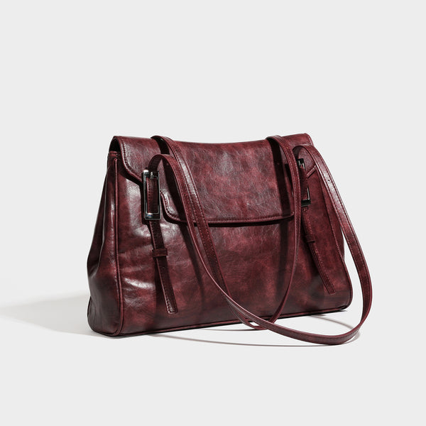Structured flap-top shoulder tote bag in distressed leather-look finish with silver-tone buckle hardware and double shoulder