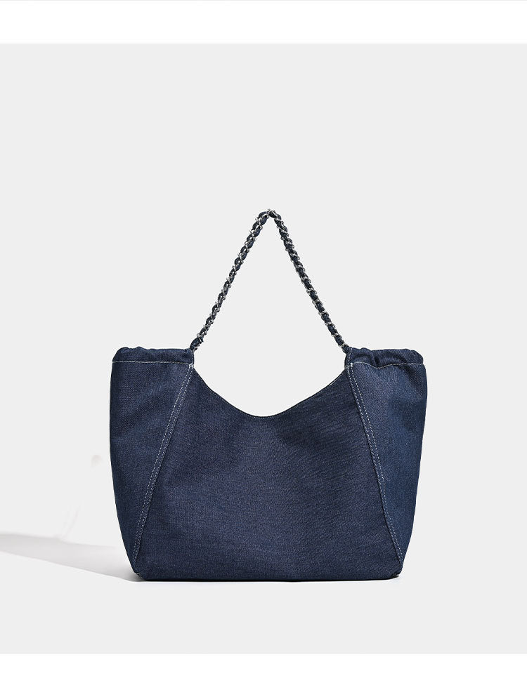 Large slouchy denim tote bag with silver-tone chain strap and contrast topstitching, detail view 9