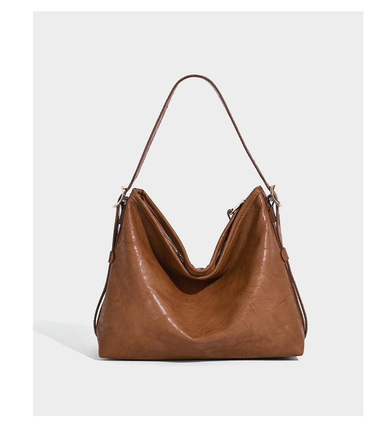 Slouchy leather-look hobo shoulder bag with gold-tone hardware and adjustable strap in brown, detail view 10