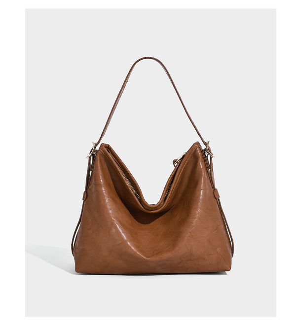 Slouchy leather-look hobo shoulder bag with gold-tone hardware and adjustable strap in brown, detail view 10