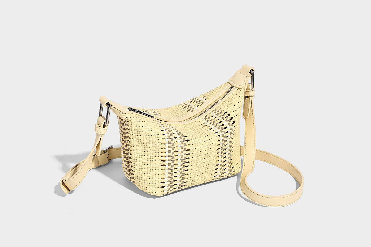 Small woven crescent shoulder bag with leather-look trim, zip closure, silver-tone ring hardware, and beaded tassel charm