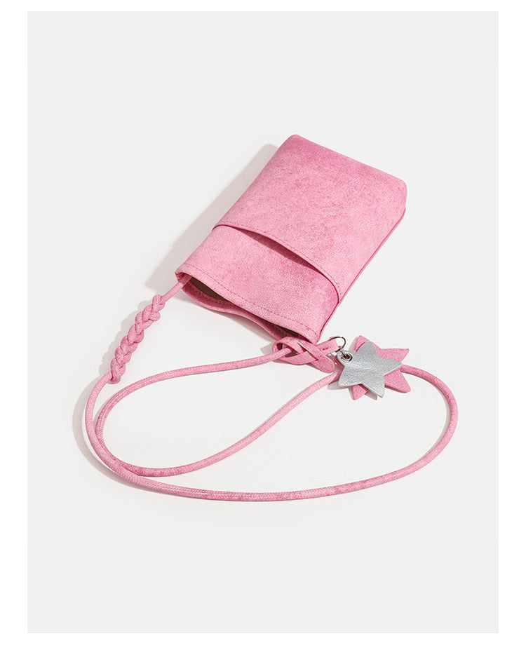 Small vertical textured mini crossbody phone bag with long braided cord strap and silver-toned star charm, detail view 10