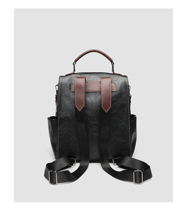 Structured black leather-look convertible backpack handbag with brown contrast trim, buckle front pocket, double-zip top