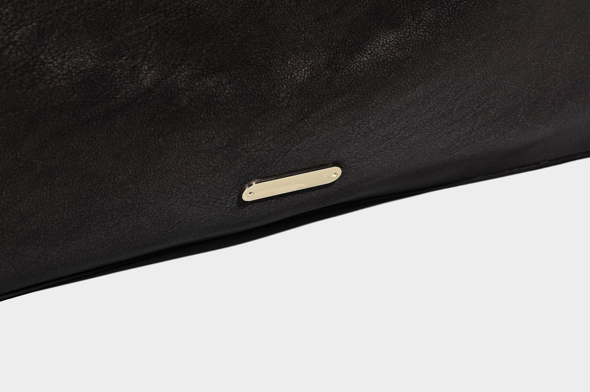 Large slouchy hobo shoulder bag in matte leather-look finish with adjustable strap and gold-tone bar hardware, detail view 21